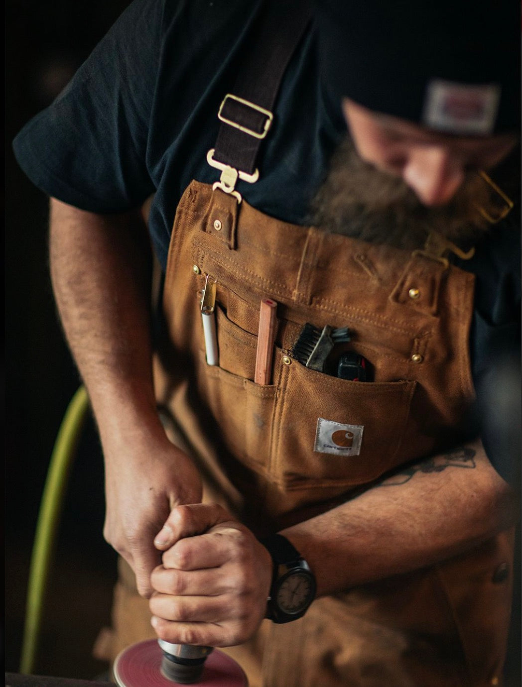 Tradesman working in brown work overalls